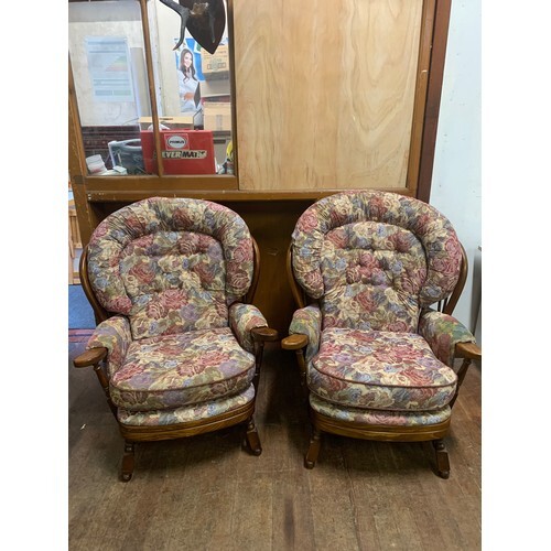 Pair of upholstered Ercol wing back arm chairs.