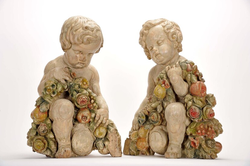 Putti kneeling and holding a garland of fruit and flowers