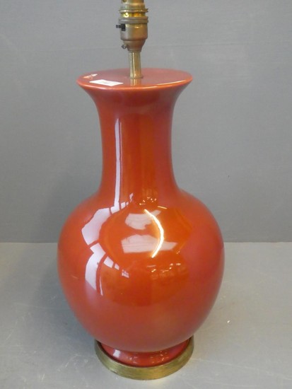 Terracotta coloured bulbous shaped lamp raised on ormolu sta...