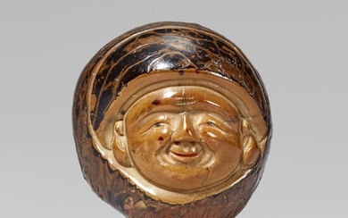 A fine large corozo nut netsuke of a god of good luck, by Masaharu. Mid-19th century