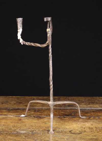 A 19th Century Wrought Iron Rush Holder with candle socket. The conical sheet metal socket on a twis