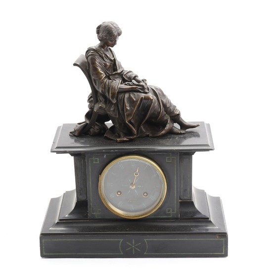 A 19th century French black marble and patinated bronze mantel clock, surmounted by memento mori figure of seated lady. H. 38 cm.