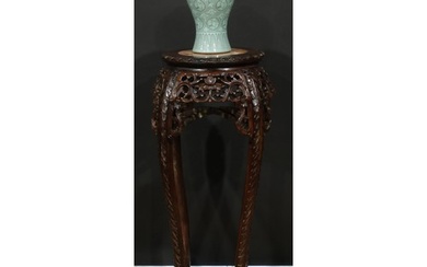 A Chinese hardwood jardiniere stand, circular top with folia...