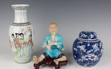 A Chinese turquoise and aubergine enamelled biscuit porcelain figure of a seated fisherman, early 20
