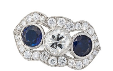 A DIAMOND AND SAPPHIRE DRESS RING set with a round cut diamond of approximately 0.52 carats between
