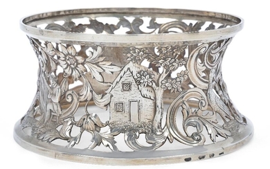 A George III Irish silver dish ring, Dublin 1786, maker FI, probably for Francis Jones, the sides pierced and engraved with foliage and scenes of thatched cottages, men drinking and dancing, a man playing the harp, various birds and a vacant...