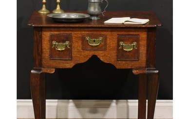 A George III oak lowboy, oversailing top with reentrant fore...