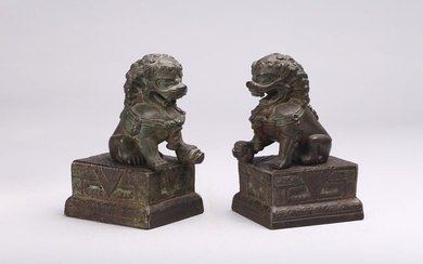 A PAIR OF CHINESE BRONZE BUDDHIST LIONS AND STANDS