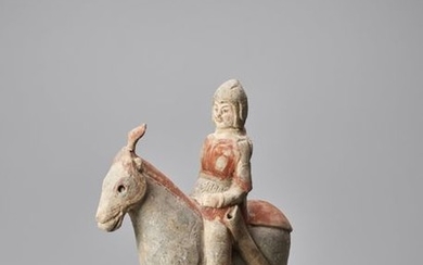A TERRACOTTA FIGURE OF A HORSE AND RIDER,...