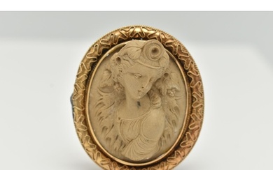 A YELLOW METAL, HIGH RELIEF LAVA CAMEO BROOCH, of an oval fo...
