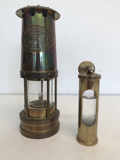 A brass oil lamp E. Thomas & Williams Ltd, Cambrian Brass Miners Paraffin Lamp. Aberdare Wales. Nr. 271362, and a brass storm glass. (2)