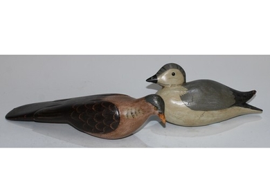 A carved softwood decoy, as a water bird, 25cm long; another...