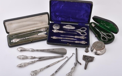 A cased Edwardian silver mounted seven piece manicure set by Robert Pringle & Sons
