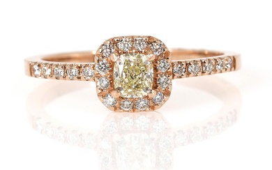 A diamond ring set with a brilliant-cut yellow diamond weighing app. 0.40...
