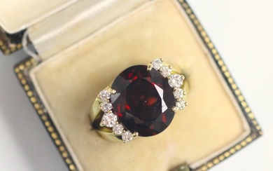 A garnet and diamond dress ring, the oval cut garnet with fi...