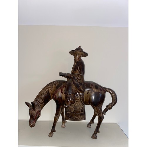 A heavy Chinese figure, of a scholar on horseback, the schol...