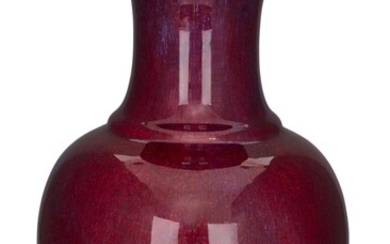 A large Chinese flambé-glazed vase, 19th century, the heavily potted vase with waisted foot rising to a globular body and a ribbed trumpet neck, covered all over with a streaked cherry-red and lavender tones, a creamy tone to rim, base unglazed...