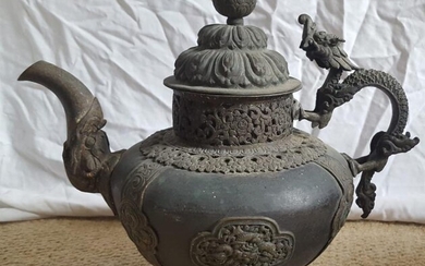 A large Tibetan copper alloy teapot with dragon handle...