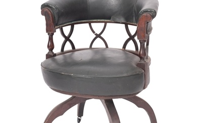A mahogany and upholstered 'cock fighting' elbow chair in Re...
