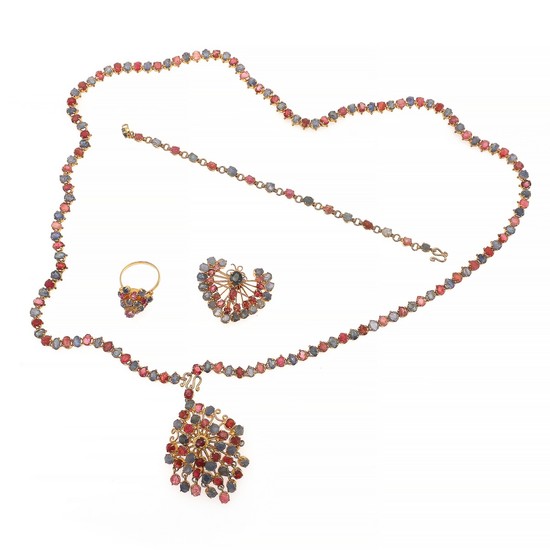 A ruby and sapphire jewellery collection comprising a necklace, a bracelet, two brooches and a ring each set with numerous rubies and sapphire, mounted in silve