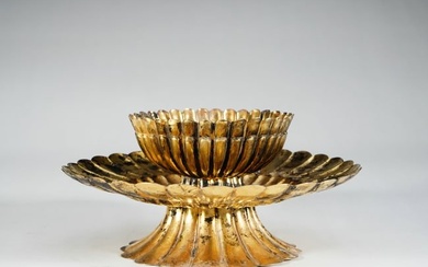A set of silver gilt teacups with flower mouths