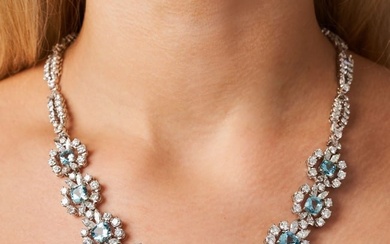 AN AQUAMARINE AND DIAMOND CLUSTER NECKLACE set with nine cushion cut aquamarines in clusters of
