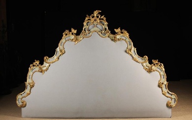 An Extravagant Super-King Sized Louis XV Style Bed Head. The arch-topped padded board upholstered wi