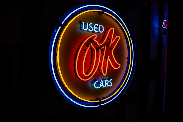 An OK Used Cars neon sign