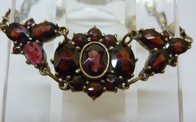 An antique bracelet with sparkling deep red garnets. <br>The center...