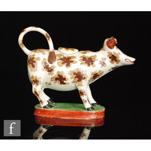 An early 19th Century cow creamer and cover, possibly Welsh,...