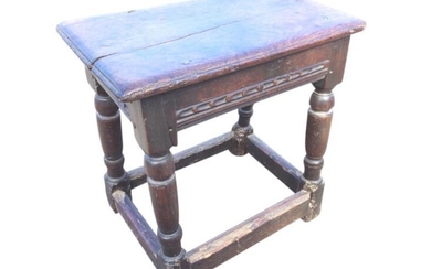 An eighteenth century oak joint stool, the rectangular dowel...