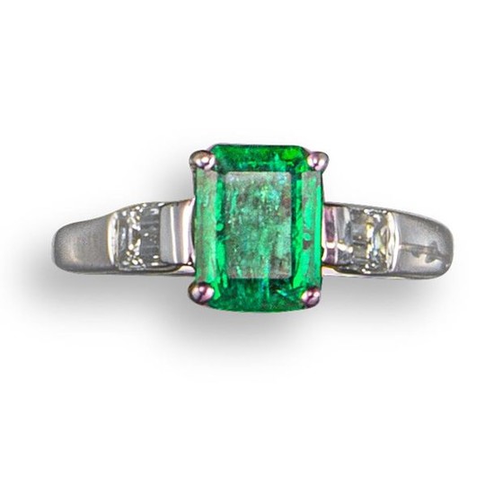 An emerald and diamond ring, the emerald-cut emerald...