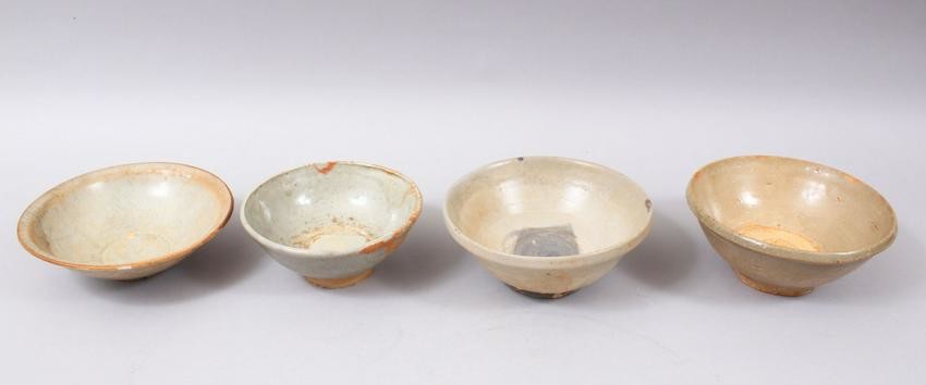 FOUR EARLY CHINESE POTTERY GLAZED BOWLS, some glazed