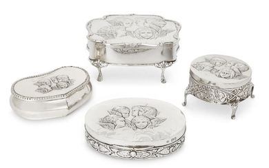 Four Victorian and Edwardian silver trinket boxes, the lid of each decorated with winged putti, the group comprising an example raised on four feet, Birmingham, 1903, Henry Matthews, 6.7cm high, 14.2cm wide, a smaller example on four feet...