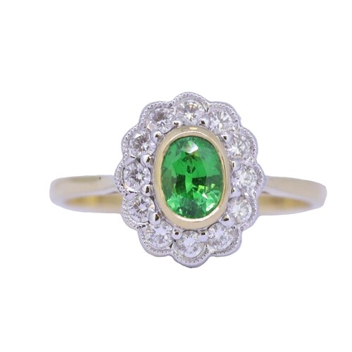 GREEN GARNET AND DIAMOND CLUSTER RING, set with a central gr...