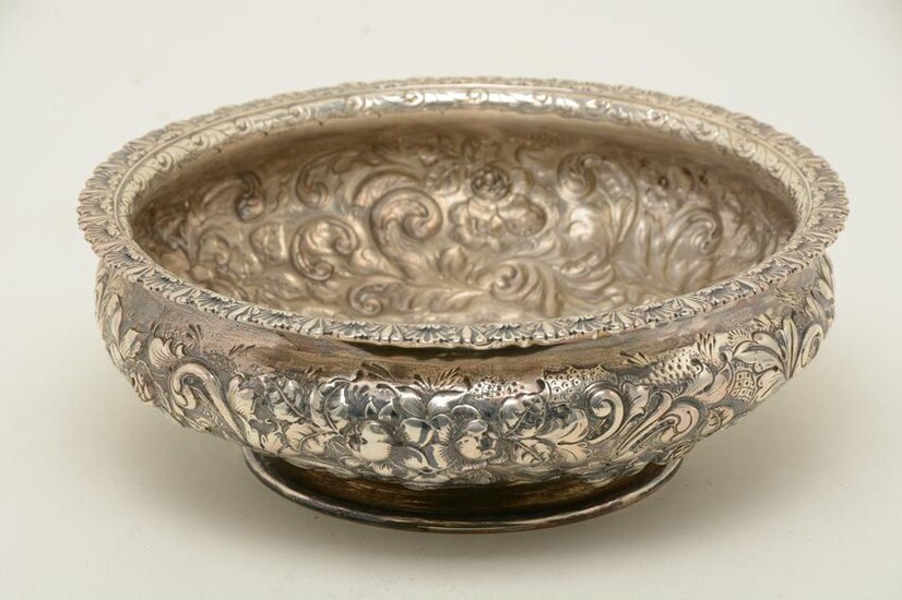 Large sterling silver repousse decorated footed bowl.