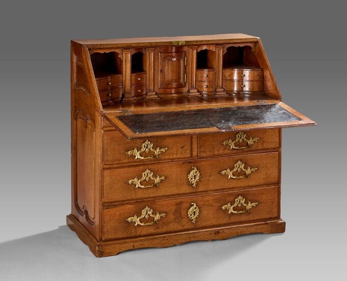 Oak scriban sideboard opening to a flap discovering writing desk, tabernacle, eight drawers and four niches and six drawers on four rows in the lower part.