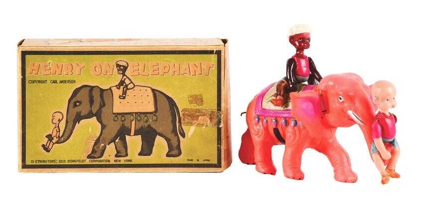 PRE-WAR CELLULOID WIND-UP HENRY ON ELEPHANT TOY.