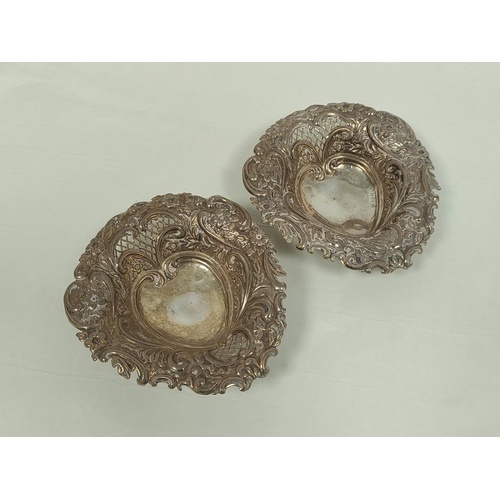 Pair of pierced and embossed bon bon dishes of heart shape, ...