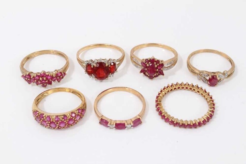 Seven 9ct gold red stone dress rings