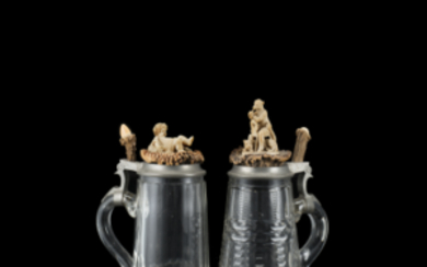 German manufacture, 19th century. A pair of tankards with decorated covers (various dimensions)
