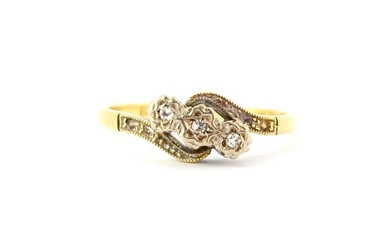 A 18ct gold and platinum diamond set crossover ring, (L.5).