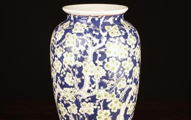 A Chinese Ceramic Vase. The ovoid body decorated with a profusion of white enamelled prunus blossom