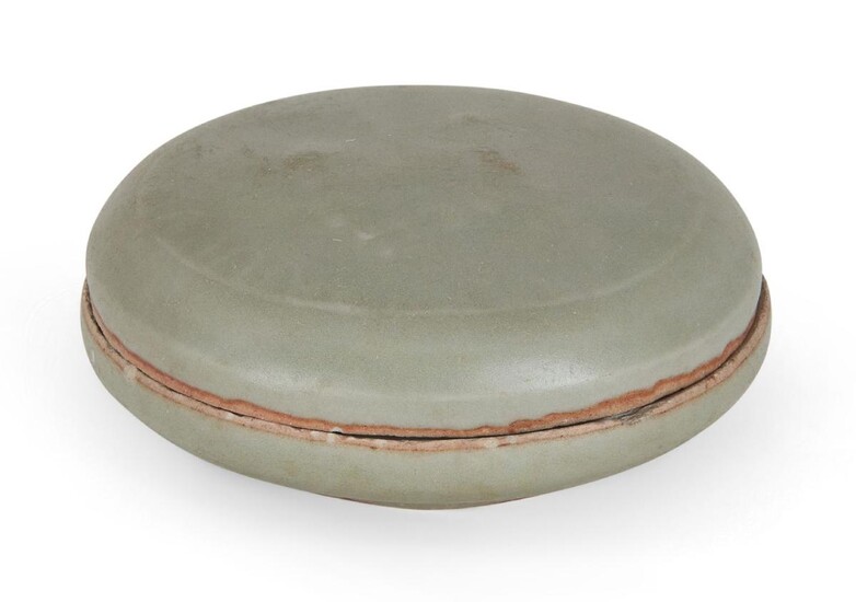 A Chinese Longquan celadon circular box and cover, Southern Song/Yuan dynasty, the cover carved with a spray of flowers within a border of petals, covered in an allover celadon glaze, 8.9cm wide