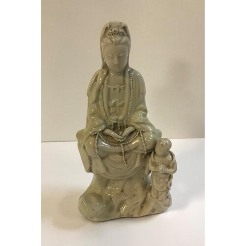 WITHDRAWN A Chinese blanc de chine figure of Guan Yin with a...