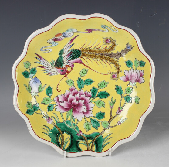 A Chinese famille rose yellow ground porcelain dish, mark of Tongzhi but later, painted with a phoen