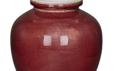 A Chinese monochrome copper red ovoid jar, 18th/19th century, with everted rim, broad unglazed footrim with white glazed recessed base, 22cm high 十八/十九世紀 紅釉罐