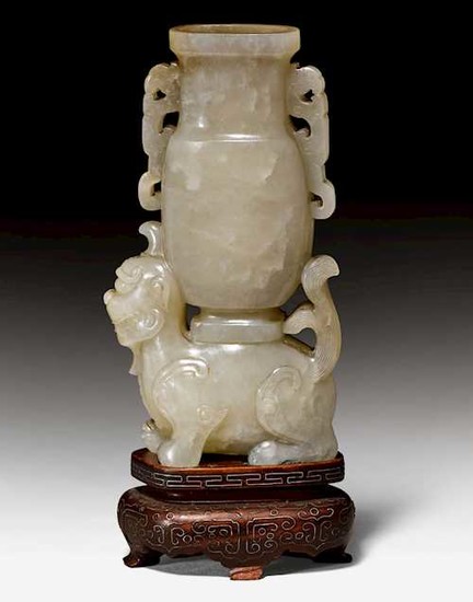 A GREYISH CELADON JADE CARVING OF A VASE ON A MYTHICAL BEAST.