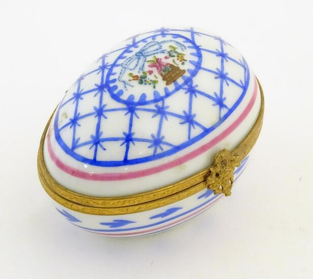A Limoges hand painted trinket box of egg form with