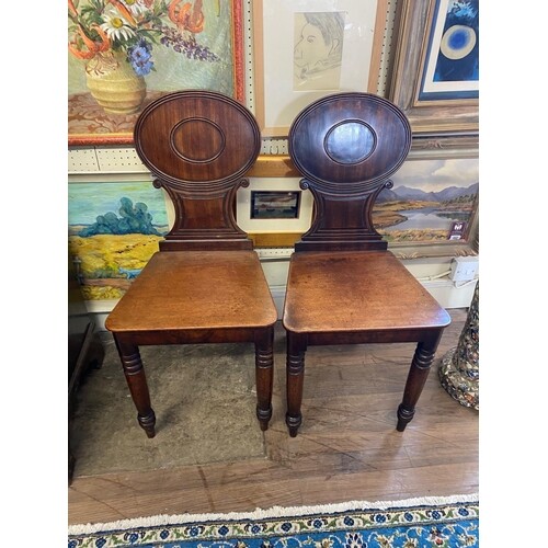 A PAIR OF EARLY 19TH CENTURY MAHOGANY HALL CHAIRS With oval ...